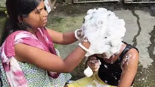 Teacher washing her student's long hair with lots of shampoo scrubbing