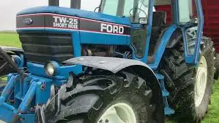 Ford TW25 short nose carting a load of soil.