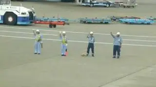 Japanese ground crew waving goodbye at AC002, Tokyo Narita Airport