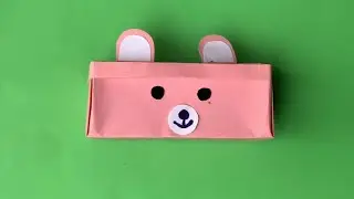 Origami - Teddy Bear Storage Box. Paper blue, pink and yellow teddy bear pencil box.