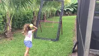 Practicing throwing and catching with a pitchback