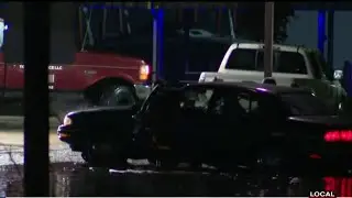 People help car stranded in flood