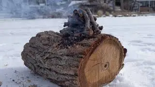 Smoldering log fire on frozen lake