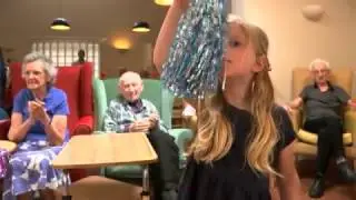 Care home residents experiencing therapy with toddlers