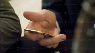 Holding gold bar in hand close up. Man holding small ingot of gold in the hand. One ounce of gold