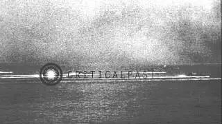 Allied LVT and LVTA crafts approach and bomb Japanese enemy positions near beache...HD Stock Footage