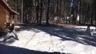 James trying his best to knock over a snowman with a frisbee