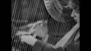 1929: Harpo Marx plays the Harp