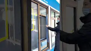 This is an aluminum-wood casement window combining metal strength with a warm wood finish