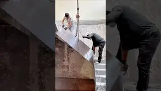 Installation of a prefabricated metal stair panel using a hoist system