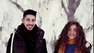 videoblocks a portrait of couple standing outdoors in snow in winter forest talking slow motion bvlq