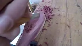 Carving a wooden cedar spoon