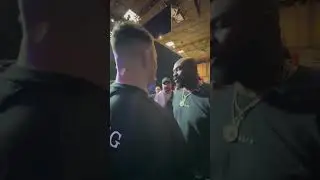 UFC Heavyweight Champion Jon Jones shrugs off Tom Aspinall's hand from his shoulder