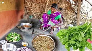 santali tribe mother cooking delicious Malabar spinach with small fish for her family||indian tribe