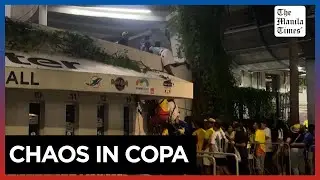 Ticketless fans climb over wall to get into Copa final