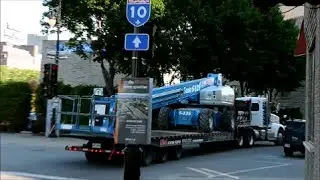 LOADING A BIG CHERRY PICKER ON A FLATBED TRUCK