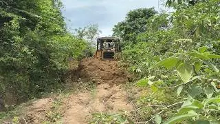 Overcoming Potholes with a D6R XL Bulldozer in a Mountain Plantation