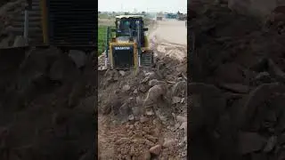 Powerful dozer pushing soil