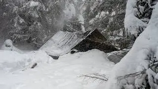 Solo bushcraft trip — massive snowfall, hanging tarp shelter, cooking on a VERTICAL campfire