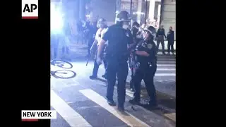 NYPD officer seen pointing gun at crowd