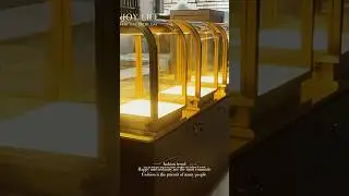 Boutique jewelry high display cabinet, curved glass, brass stainless steel, black wood grain.