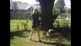 Woman Mows Yard With Dust Flying Up in slow motion mowing the grass using lawn mower to mow