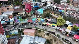VideoVault Stock Video: Medellin Colombia street with shops and graffiti aerial view