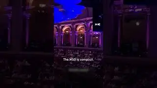 Activists chant against the Melbourne Symphony Orchestra, disrupting the BBC Proms