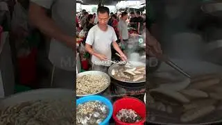 Authentic Market Cuisine: Sago Worms and Sea Cucumbers Cooked in a Traditional Market.