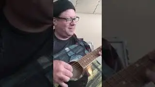 Vic Volare with April 2021 auction item. Signed guitar by Tito of Tito's vodka.