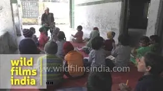 Girls and boys learn school rhymes in a remote Himalayan village