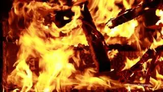 Wood, fire and an armchair. Filmed with the Canon 1dx Mark II. In slowmotion. Sample video.