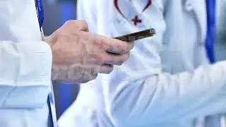 Healthcare professionals using smartphone for medical forum and online communication