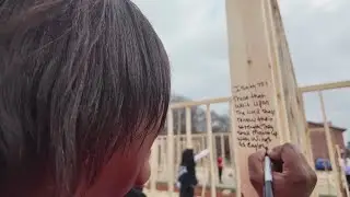 Volunteers raise walls for new homes