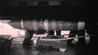 Crewmen attach halyards to a bomb on a dolly near a US Navy AJ Savage aboard USS ...HD Stock Footage
