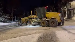 Champion road grader Plowing snow in residential streets of Ottawa