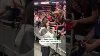 Caitlin Clark signing for fans before Game 3