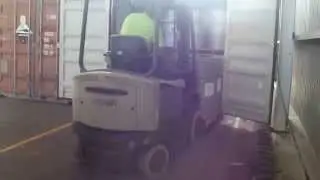 Loading pallets of drums into a container