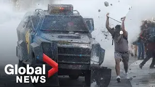 Chile protests: Demonstrators clash with security force vehicles in Santiago