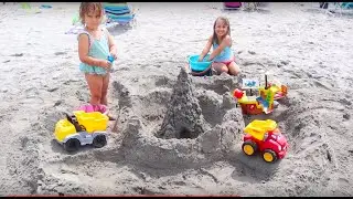 Kids playing on the beach. Making a HUGE sand castle.