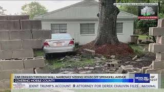 VIDEO: Car crashes through wall, narrowly missing house off Springhill Avenue