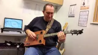 The Haystack Banjos Black and Tan box guitar being tested by Peter Arnold at The Hub in Diss.