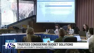 Douglas County School Board of Trustees review consolidation options after declaring a financial...