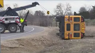 Idaho school bus towed from ditch after flipping on side