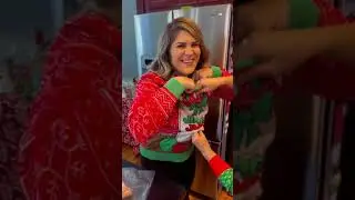 Woman is showing off the funny Christmas sweater that her mother bought for her!