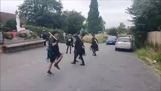 Tannerman by Anderida Border Morris in the road outside The Long Man Inn at Wilmington
