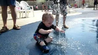 Connor playing with the water at Duke's Lagoon at Dutch Wonderland