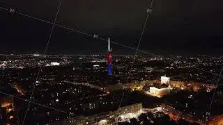 Zizkov television tower rises prominently above the Prague skyline and sparkling city lights at