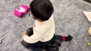 Aidan sits and rides car indoor kids play