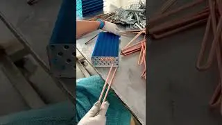 Assembling copper heat pipes into blue aluminum cooling fins for efficient thermal heat exchanger